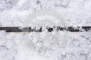 Aerial view of winter beautiful landscape road with trees covered with hoarfrost and snow. Winter scenery from above. Landscape