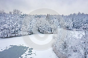 Aerial view of winter beautiful landscape with trees covered with hoarfrost and snow. Winter scenery from above. Landscape photo