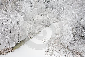 Aerial view of winter beautiful landscape with trees covered with hoarfrost and snow. Winter scenery from above. Landscape photo