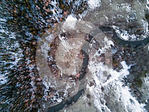 Aerial view of winter forest covered in snow and frost.