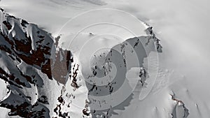 Aerial view winter mountain alpine panorama dive on snowy cliff ridge freeze glacier landscape