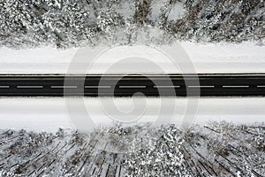 Aerial view of the winter road through forest