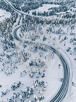 Aerial view winter of road in the forest covered with snow, Finland Lapland