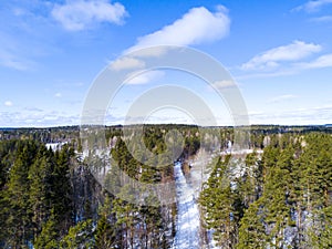 Aerial view of a winter road. Winter landscape countryside. Aerial photography of snow forest. Captured from above with a drone. A