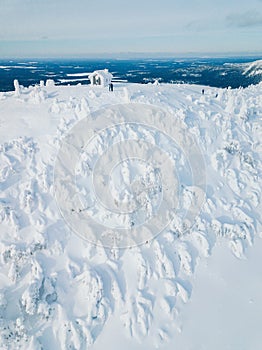 Aerial view of winter snow covered wood hut. Frozen log cabin in Finland