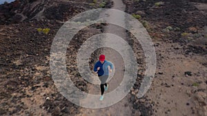 Aerial view of woman runnning along the nature reserve at sunrise. Healthy active lifestyle