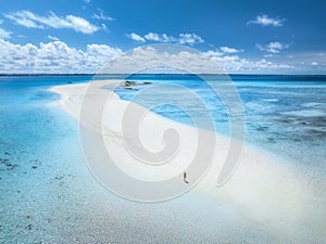 Aerial view of woman, sandbank, white sand, sea in low tide