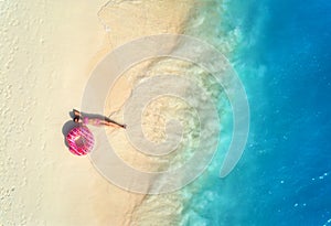 Aerial view of woman with swim ring on the sandy beach