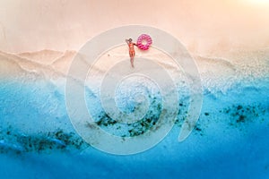 Aerial view of woman with swim ring on the sandy beach