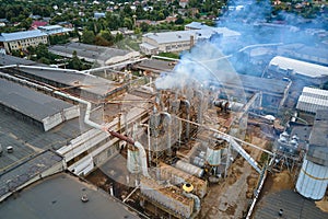 Aerial view of wood processing factory with smoke from production process polluting atmosphere at plant manufacturing