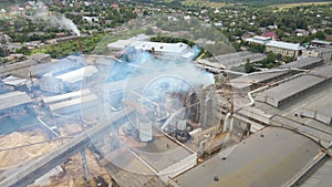 Aerial view of wood processing factory with smoke from production process polluting atmosphere at plant manufacturing