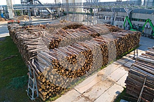 Aerial view of wood processing factory with stacks of lumber at plant manufacturing yard