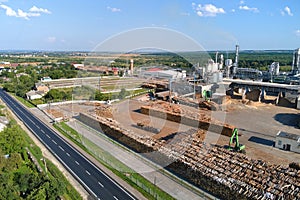 Aerial view of wood processing factory with stacks of lumber at plant manufacturing yard