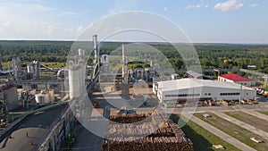 Aerial view of wood processing factory with stacks of lumber at plant manufacturing yard