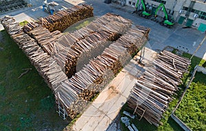 Aerial view of wood processing factory with stacks of lumber at plant manufacturing yard