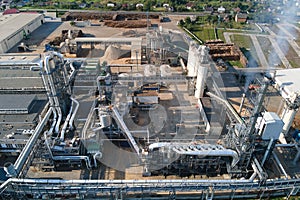 Aerial view of wood processing factory with stacks of lumber at plant manufacturing yard