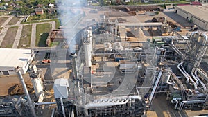 Aerial view of wood processing factory with stacks of lumber at plant manufacturing yard