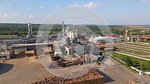 Aerial view of wood processing factory with stacks of lumber at plant manufacturing yard