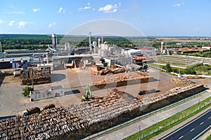 Aerial view of wood processing factory with stacks of lumber at plant manufacturing yard