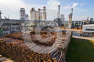 Aerial view of wood processing factory with stacks of lumber at plant manufacturing yard