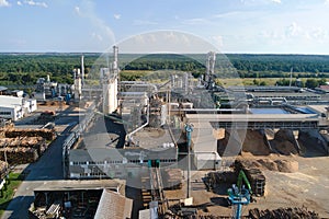 Aerial view of wood processing factory with stacks of lumber at plant manufacturing yard