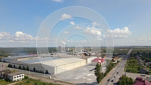 Aerial view of wood processing factory with stacks of lumber at plant manufacturing yard