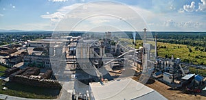 Aerial view of wood processing factory with stacks of lumber at plant manufacturing yard