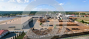 Aerial view of wood processing factory with stacks of lumber at plant manufacturing yard