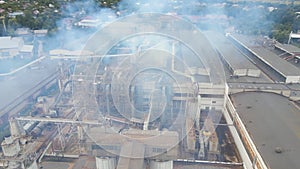 Aerial view of wood processing plant with smokestack from production process polluting environment at factory