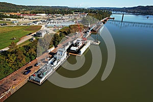 Aerial view of wood trees by large Barge on Ohio River boats, on a sunny day