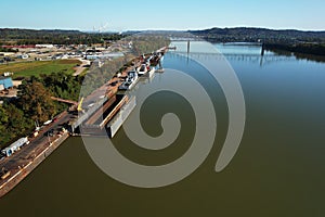 Aerial view of wood trees by large Barge on Ohio River boats, USA with blue sky