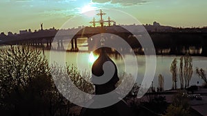 Aerial view of a wooden church with a large golden cross near the wide river Dnieper in Kiev