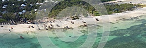 Aerial view of wooden fisherman boats and sandy beach at Kendwa village at sunny day,