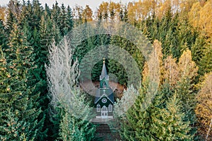Aerial view of wooden rural chapel called Tichackova kaple in Broumovsko region,Czech republic.Catholic church in autumn