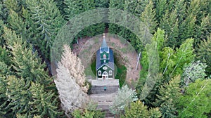 Aerial view of wooden rural chapel called Tichackova kaple in Broumovsko region,Czech republic.Catholic church in spring