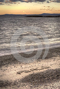 Aerial View of the Word Peace on a Beach