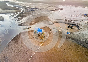 Aerial view of a work site excavating sand on an islet for shell breeding.