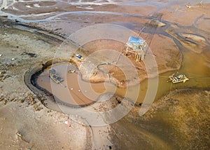 Aerial view of a work site excavating sand on an islet for shell breeding.