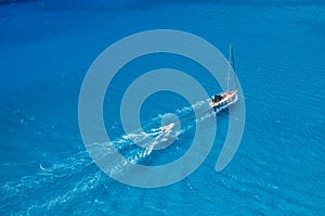 An aerial view of the yacht on the azure sea. Transparent clear water in the Mediterranean Sea. Summer vacations and travels on a