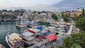 Aerial view of yacht harbor and red house roofs in "Old town" day to night timelapse Antalya, Turkey.