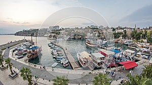 Aerial view of yacht harbor and red house roofs in Old town day to night timelapse Antalya, Turkey.