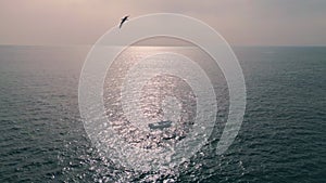 Aerial view yacht sailing. Boat floating on calm ripple ocean surface at summer