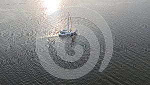 Aerial view of yacht sailing in Dnieper river on sunset