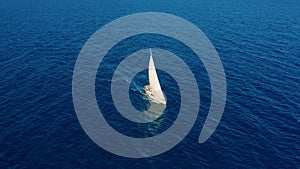 Aerial view. Yacht sailing on open sea at sunny day. Sailing boat in sea.