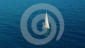 Aerial view. Yacht sailing on open sea at sunny day. Sailing boat in sea.