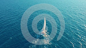 Aerial view. Yacht sailing on open sea at sunny day. Sailing boat in sea.