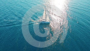 Aerial view. Yacht sailing on open sea at sunny day. Sailing boat in sea.