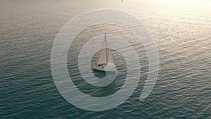 Aerial view. Yacht sailing on opened sea. Sailing boat. Yachting video footage. Yacht from above. Sailboat view from