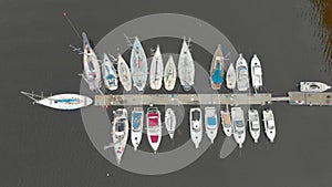 Aerial view on a yaght and boats parking in a calm bay