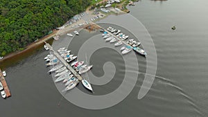 Aerial view on a yaght and boats parking in a calm bay